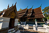 Wat Xieng Thong temple in Luang Prabang, Laos. The pointed arch brick and stucco shrine with inside is a standing Buddha statue. 